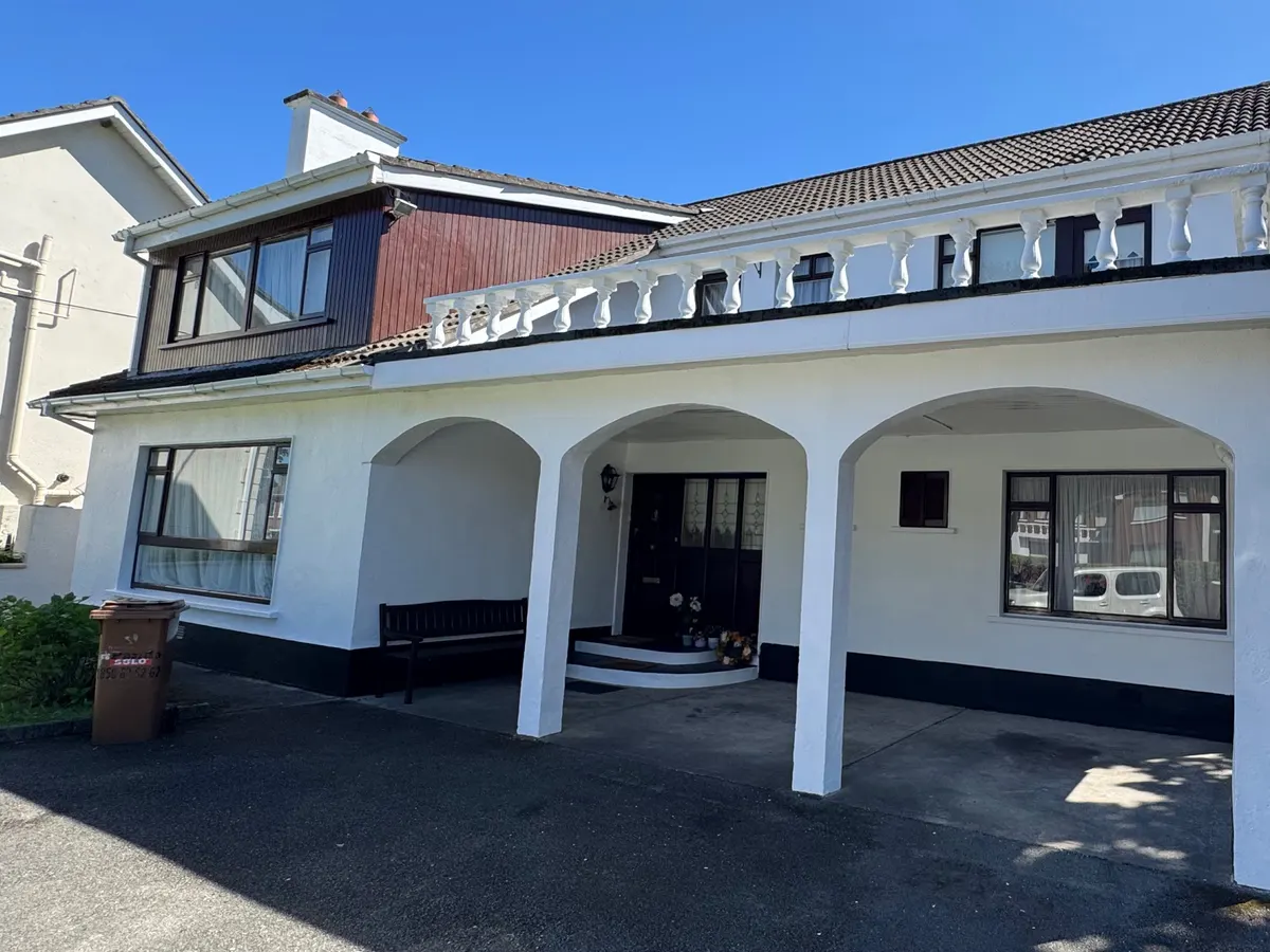 Finished front of the same Castleknock house: white walls, arches and balustrade over a black plinth, Dublin 15