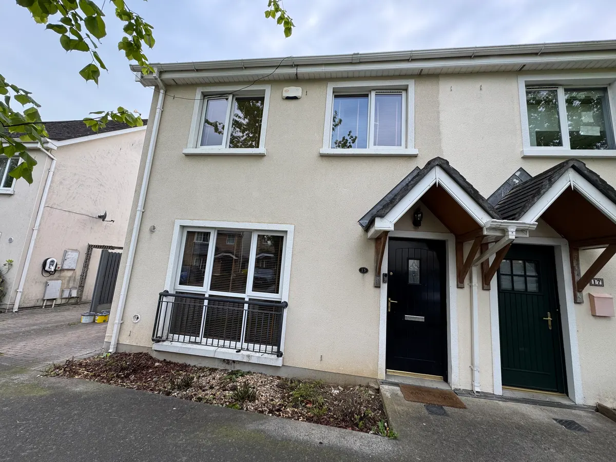 Before: pair of semi-detached houses in Lusk, Co. Dublin, with weathered cream render and white window surrounds