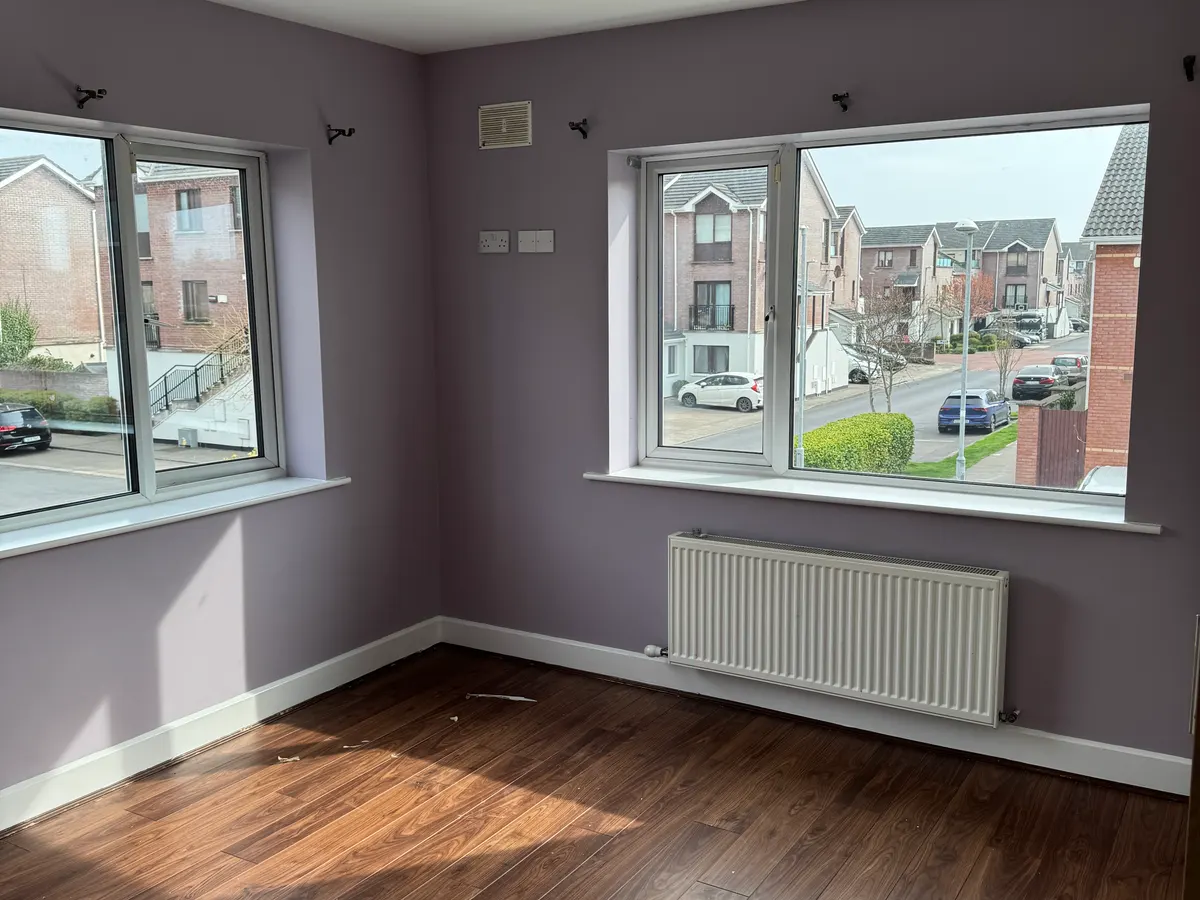 Bedroom with lilac walls, white skirting and window boards, and a wooden floor, Rush, Co. Dublin