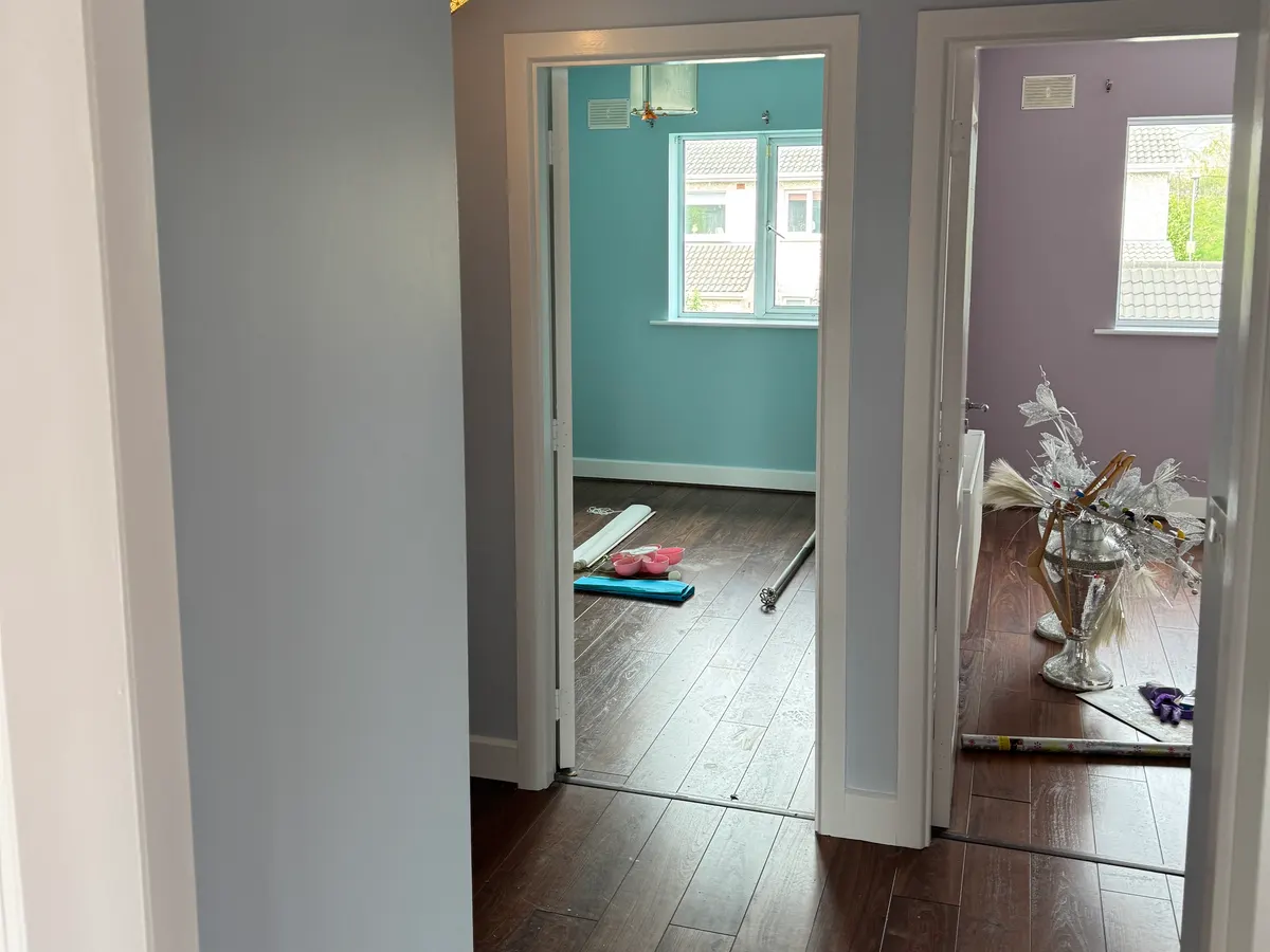 Pale grey landing looking into a turquoise bedroom and a lilac bedroom, house in Rush, Co. Dublin