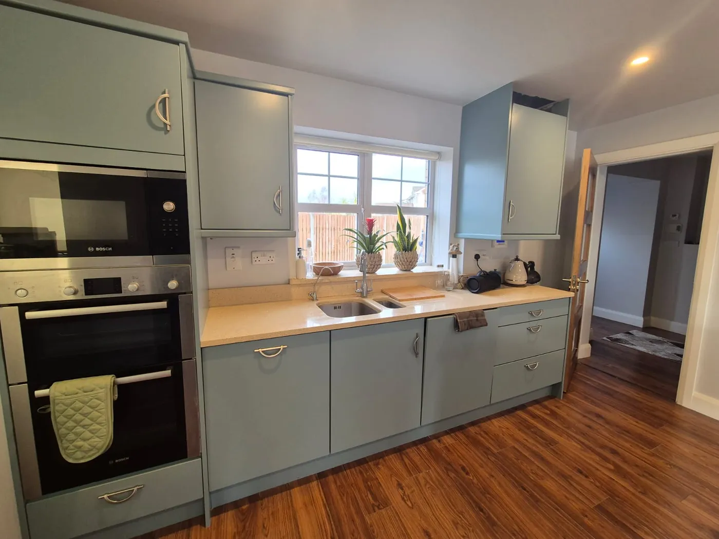 Freshly painted duck-egg blue fitted kitchen cabinets in a Dublin home