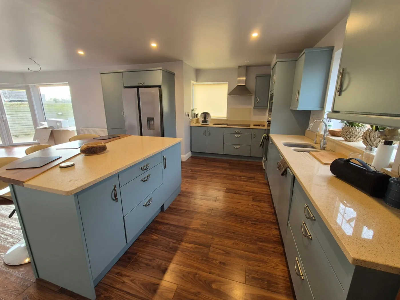 Freshly painted blue-grey kitchen cabinets with island in a Dublin home