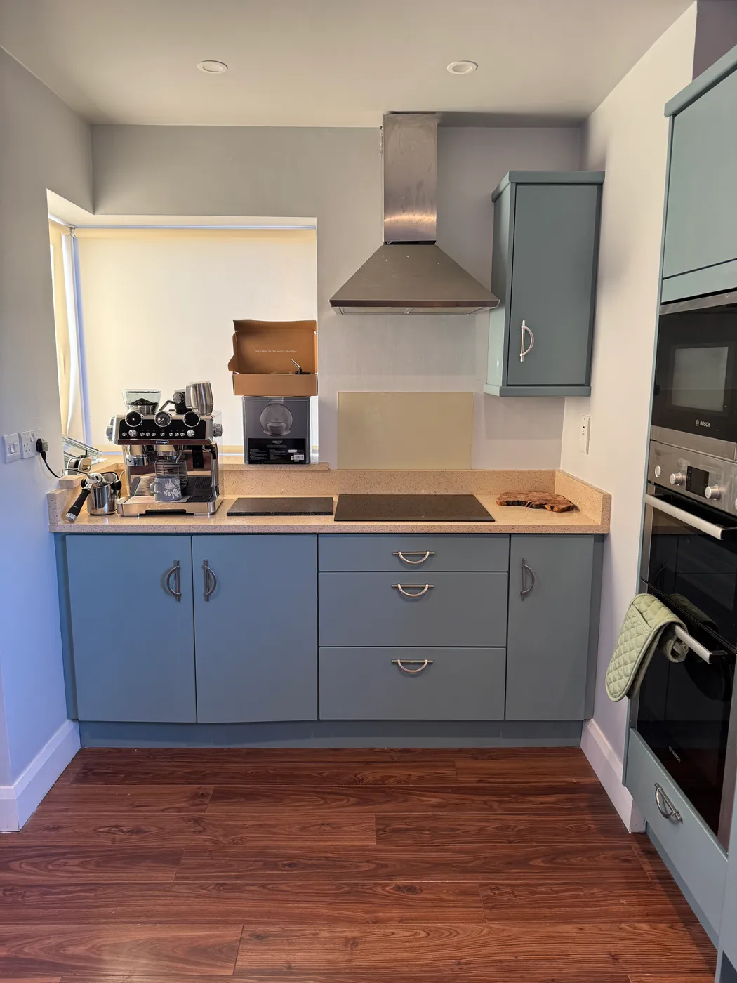 Freshly painted blue kitchen cabinets with wood countertop in a Dublin kitchen