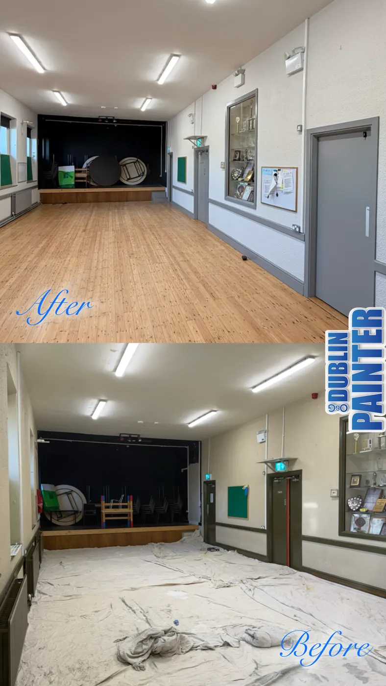 Freshly painted community hall corridor with trophy case and stage in Dublin