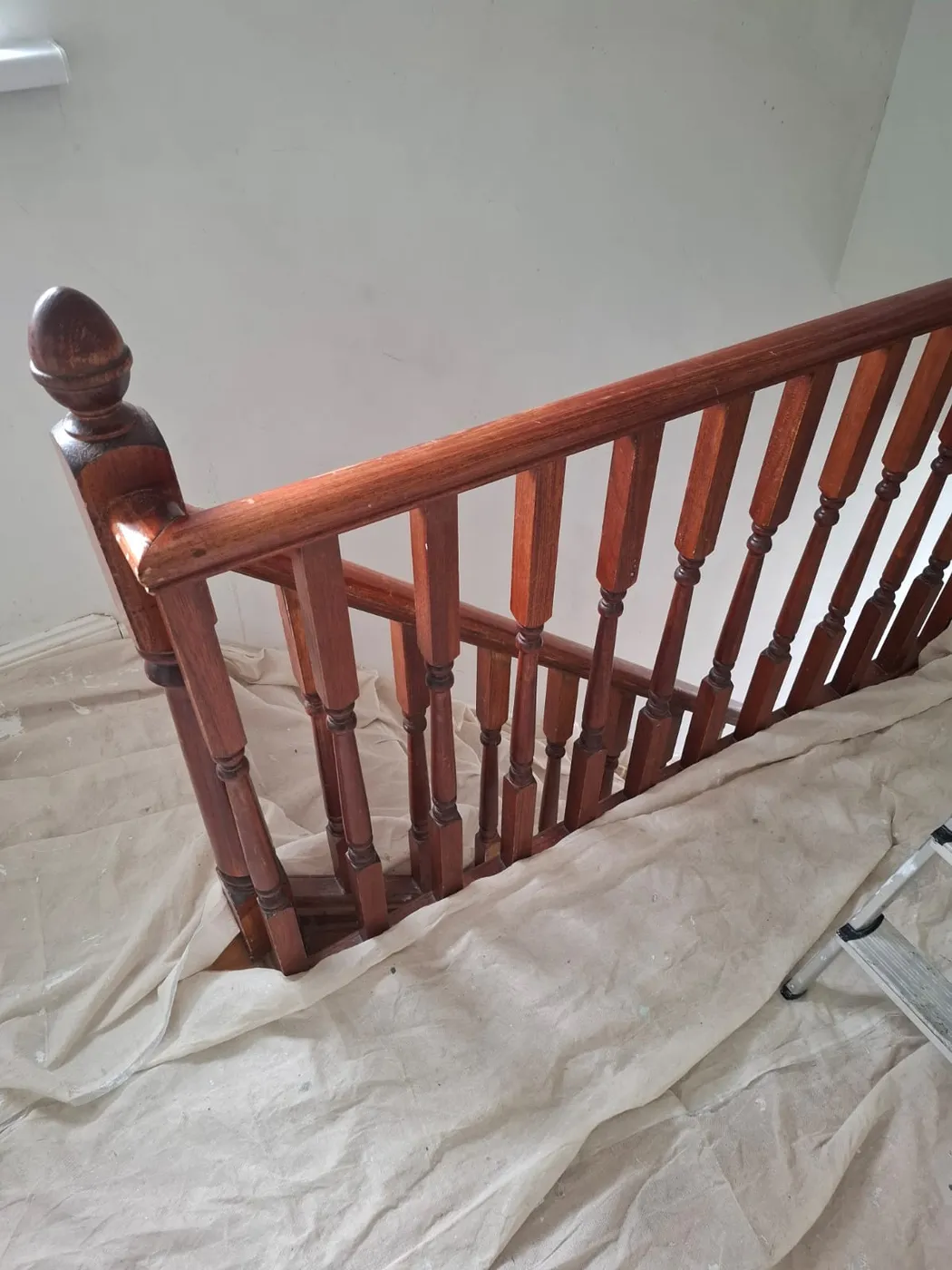 Dark stained timber staircase newel post and balustrade in a Dublin home