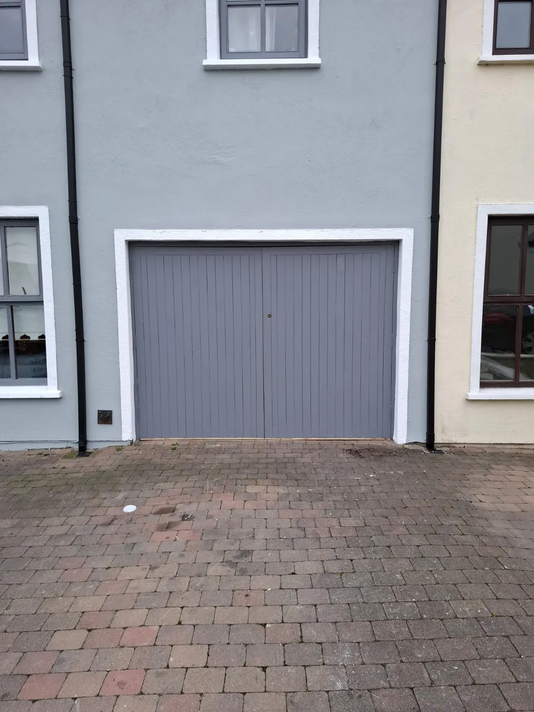 Freshly painted grey double garage door on a Dublin house
