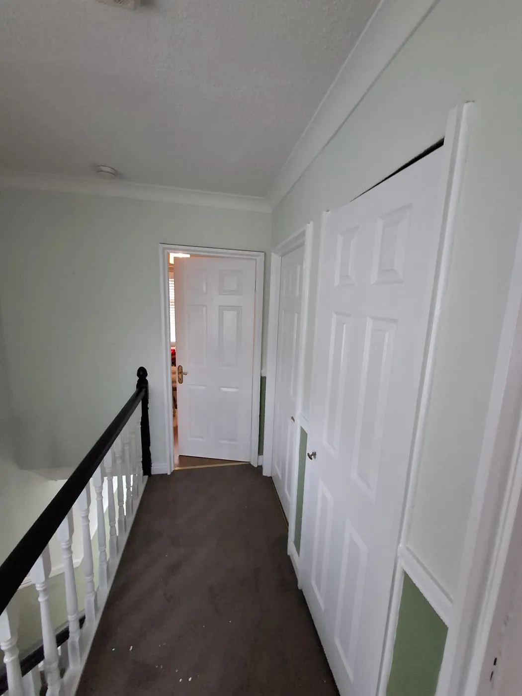 White panelled bedroom door freshly painted in a Dublin upstairs hallway