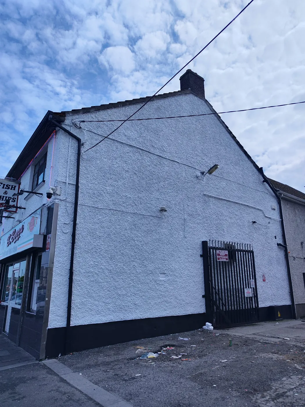 Freshly painted white two-storey Dublin house exterior with balcony and archway porch